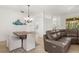 Open-concept living room and dining area with tile flooring and plenty of natural light at 2292 Harrier Way, Nokomis, FL 34275