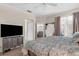 Spacious main bedroom features a large TV and access to an outside area at 2292 Harrier Way, Nokomis, FL 34275