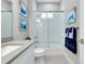 Bright bathroom featuring a shower with a glass door and white subway tile, plus modern fixtures and blue decor at 265 Bocelli Dr, Nokomis, FL 34275