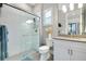 Bathroom featuring a modern shower with glass doors, white subway tile, and a stylish vanity with neutral countertop at 265 Bocelli Dr, Nokomis, FL 34275