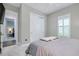 Neutral-toned bedroom with soft carpeting, light walls, and plantation shutters for diffused natural light at 265 Bocelli Dr, Nokomis, FL 34275