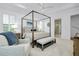 Bright bedroom featuring a four-poster bed, wood furniture, seating area and plenty of natural light at 265 Bocelli Dr, Nokomis, FL 34275