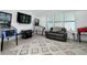 Large game room features tile flooring, game machines, comfortable seating and ample space for entertainment at 265 Bocelli Dr, Nokomis, FL 34275