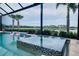 The backyard oasis features a mosaic-tiled spa and pool area with landscaping, creating a tranquil setting at 265 Bocelli Dr, Nokomis, FL 34275