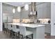 Modern kitchen with a large island, stainless steel appliances, and sleek gray cabinetry at 265 Bocelli Dr, Nokomis, FL 34275
