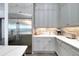 Elegant kitchen featuring stainless steel appliances, quartz countertops, and custom cabinetry at 265 Bocelli Dr, Nokomis, FL 34275