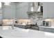 Well appointed kitchen features custom cabinets, stainless steel appliances, and a large center island at 265 Bocelli Dr, Nokomis, FL 34275