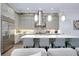 Kitchen with stainless steel appliances, an island with bar stool seating and pendant lighting at 265 Bocelli Dr, Nokomis, FL 34275