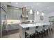 Kitchen with stainless steel appliances, large island with seating, and modern lighting fixtures at 265 Bocelli Dr, Nokomis, FL 34275