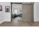 View of the hardwood floors through a doorway with a gray sliding barn door at 265 Bocelli Dr, Nokomis, FL 34275