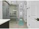Spacious main bathroom showcasing a modern glass shower with a built-in bench and pebble flooring at 265 Bocelli Dr, Nokomis, FL 34275