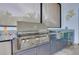 Close-up of the outdoor kitchen's stainless steel gas grill with counter space and sink at 265 Bocelli Dr, Nokomis, FL 34275