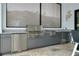 A stainless steel outdoor kitchen provides ample space for cooking and food preparation, with a built-in grill and sink at 265 Bocelli Dr, Nokomis, FL 34275
