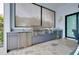 Well-equipped outdoor kitchen with stainless steel appliances, including a grill, sink, and beverage cooler at 265 Bocelli Dr, Nokomis, FL 34275