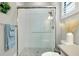 Modern shower with subway tile surround and glass doors, complemented by a neutral vanity and stylish decor at 265 Bocelli Dr, Nokomis, FL 34275
