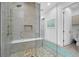 Modern bathroom with a frameless glass shower featuring a tile surround and bench seat at 265 Bocelli Dr, Nokomis, FL 34275