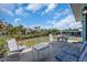 Back patio featuring outdoor furniture with a view of the lush backyard landscaping and waterfront at 328 Channel Ln, Nokomis, FL 34275