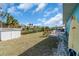 Spacious backyard with a shed, lawn furniture, and a surfboard against the exterior of the turquoise colored house at 328 Channel Ln, Nokomis, FL 34275