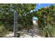 Scenic beach access path through lush vegetation leads to the sandy shores and ocean views at 328 Channel Ln, Nokomis, FL 34275