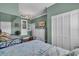 A bedroom featuring a white closet, doorway, and light green walls alongside the bed at 328 Channel Ln, Nokomis, FL 34275