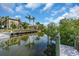 Waterfront property with private dock and lush tropical landscaping at 328 Channel Ln, Nokomis, FL 34275