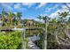 Waterfront home with a private dock and boat access surrounded by tropical landscaping at 328 Channel Ln, Nokomis, FL 34275