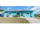 Charming, bright blue single-story home with well-maintained lawn and inviting entrance at 328 Channel Ln, Nokomis, FL 34275