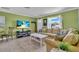 Cozy living room with tile floors, comfortable seating, and a view of the outdoors at 328 Channel Ln, Nokomis, FL 34275