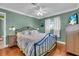Spacious main bedroom featuring warm wood floors, ceiling fan, and lots of natural light at 328 Channel Ln, Nokomis, FL 34275