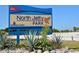 Brightly colored park sign for North Jetty Park, surrounded by lush greenery and foliage, inviting visitors to explore at 328 Channel Ln, Nokomis, FL 34275