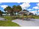 Shaded picnic area with wooden tables and lush greenery, offering a serene spot for outdoor gatherings and relaxation at 328 Channel Ln, Nokomis, FL 34275