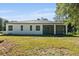 The backyard features a covered lanai and a spacious lawn at 3470 Elias Cir, North Port, FL 34288