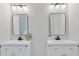 Bathroom with double vanity sinks, modern mirrors, and neutral color scheme at 3470 Elias Cir, North Port, FL 34288