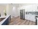 Modern kitchen featuring white cabinets, stainless steel appliances, and a sleek backsplash at 3470 Elias Cir, North Port, FL 34288