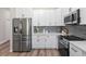 Modern kitchen with stainless steel appliances and white shaker cabinets at 3470 Elias Cir, North Port, FL 34288