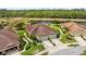 Beautiful aerial view of home featuring meticulous landscaping, pond, and attached two-car garage at 371 Capulet Dr, Venice, FL 34292