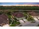 Stunning aerial view of a home with lush landscaping and a beautiful pond in a desirable community at 371 Capulet Dr, Venice, FL 34292