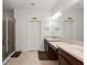 Bathroom with dual sinks, a glass shower, and tile flooring for a clean, modern look at 371 Capulet Dr, Venice, FL 34292