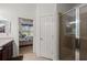 Bathroom doorway leading to the bedroom with an adjacent glass-walled shower at 371 Capulet Dr, Venice, FL 34292