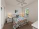 Bedroom featuring a ceiling fan and white dressers with beach-themed art at 371 Capulet Dr, Venice, FL 34292