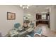 A dining room with a glass table and wicker chairs in an open floor plan with a tiled floor at 371 Capulet Dr, Venice, FL 34292