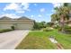 Home exterior featuring a well-manicured lawn, nice landscaping, and a two-car garage at 371 Capulet Dr, Venice, FL 34292