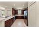 Contemporary kitchen featuring stainless steel appliances and dark wood cabinetry at 371 Capulet Dr, Venice, FL 34292