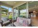 Comfortable screened lanai with cozy seating, view of the backyard and home's interior at 371 Capulet Dr, Venice, FL 34292