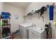Functional laundry room with white washer and dryer, a utility sink, and ample storage space at 371 Capulet Dr, Venice, FL 34292
