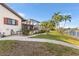 Home with palm trees, a grassy backyard, a screened-in porch, and a boat dock at 3819 Aves Island Ct, Punta Gorda, FL 33950