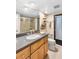 Bathroom featuring granite counters, wood cabinets, a large mirror, and a glass-enclosed shower at 3819 Aves Island Ct, Punta Gorda, FL 33950