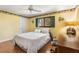 Bedroom featuring yellow walls, wood flooring, a ceiling fan, and a desk at 3819 Aves Island Ct, Punta Gorda, FL 33950