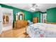 Bright bedroom with hardwood floors, green walls, ceiling fan and wood furniture at 3819 Aves Island Ct, Punta Gorda, FL 33950
