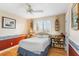 Bedroom features hardwood floors, a ceiling fan, a bed, and light tan walls at 3819 Aves Island Ct, Punta Gorda, FL 33950
